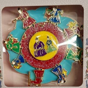 NEW, in original box, rotating enamel magnet